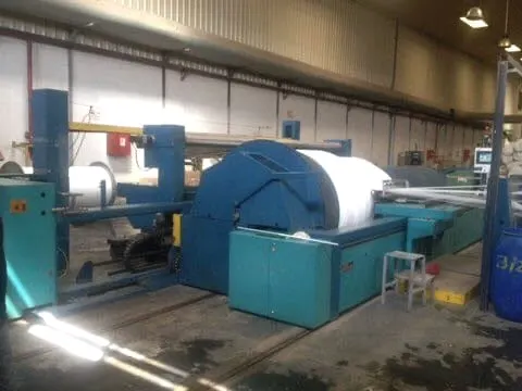 Blue sectional warping machine with a white warp sheet